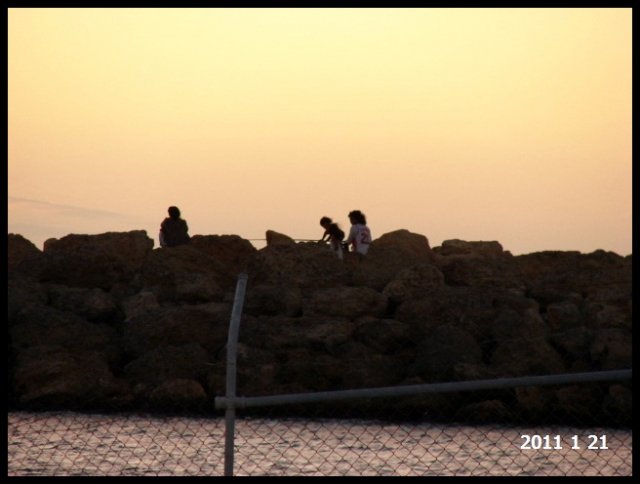 Silhouettes on sunset ASI groyne